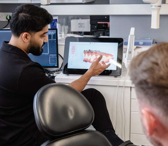 Dentist showing 3D scan to patient